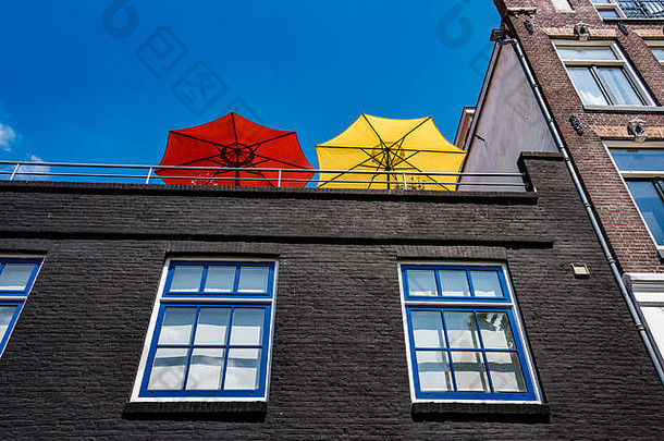 红色的黄色的阳伞高阳台蓝色的白色蓝色的窗户