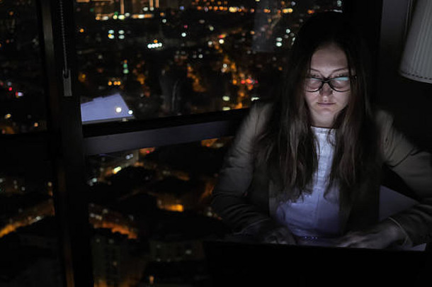 浅黑肤色的女人女人眼镜工作电脑窗口首页晚上年轻的自由职业者加班工作自由自由职业者概念Copyspace