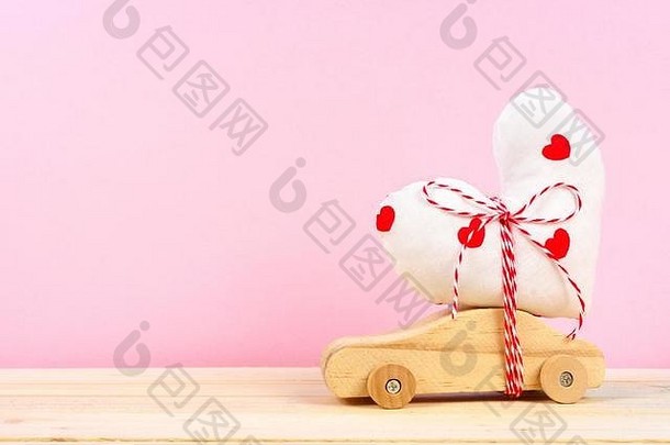 木玩具车携带自制的心礼物粉红色的背景情人节一天爱概念