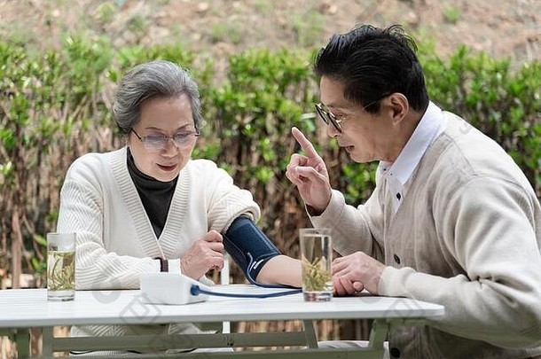 亚洲上了年纪的夫妇测量血压力