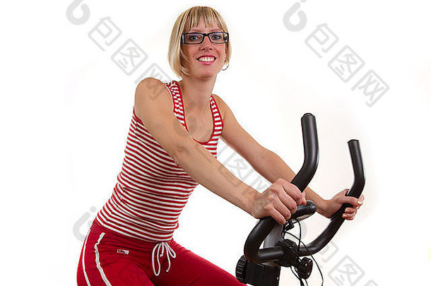 年轻的女人红色的锻炼自行车