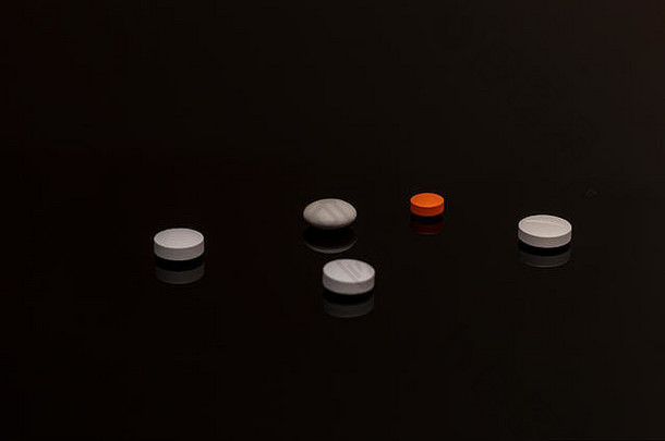 堆色彩斑斓的药物药片黑色的背景
