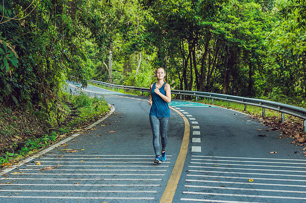 运动女人运行路日出健身锻炼健康概念