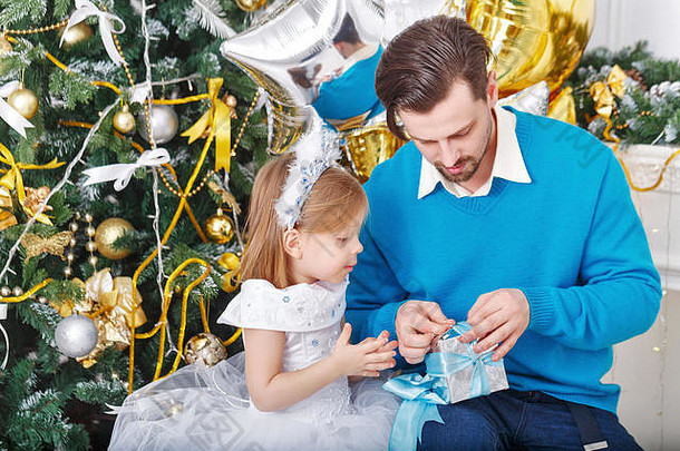 女儿父亲礼物圣诞节树父亲解包礼物女儿可爱的女孩